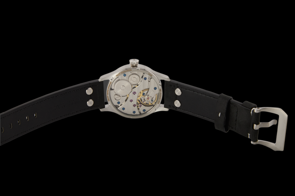 Watch with black leather strap and silver case on a black background